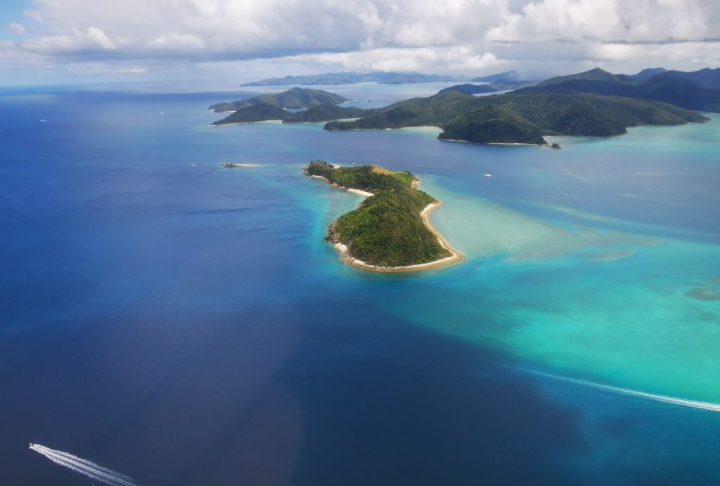 Island in the middle of blue water Whitsunday Islands Australia