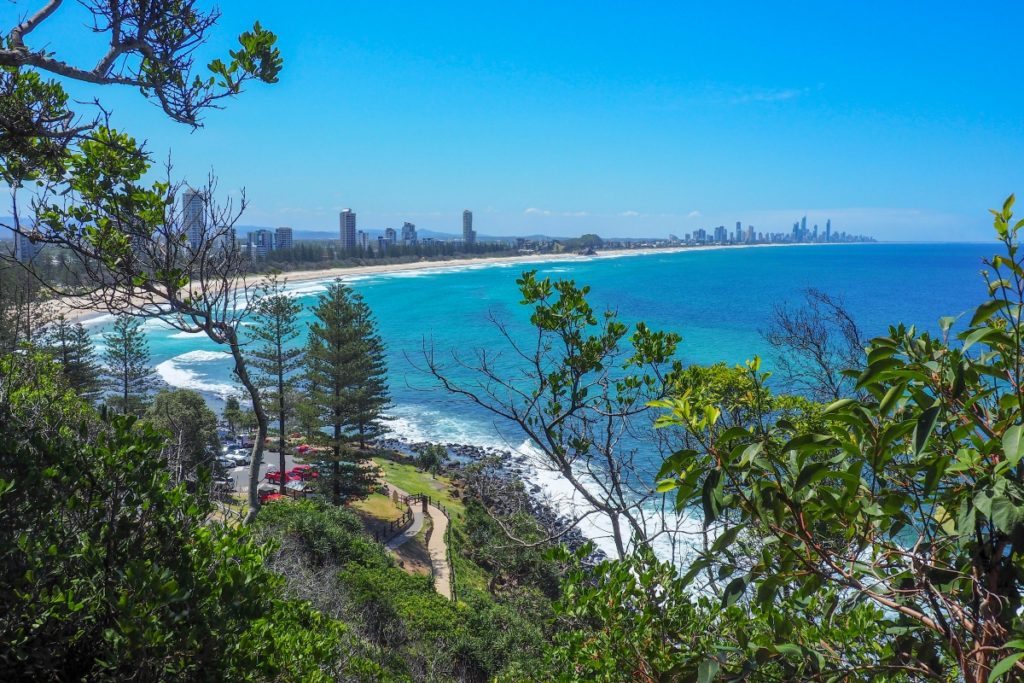 View on the coast with clear water from an elevated spot in the forrest on Pacific Coast Road in Australia.