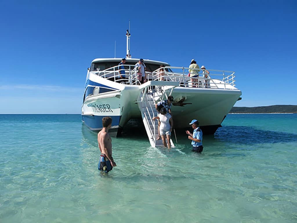 Boat with people descending for an excursion on the Whitsunday Islands