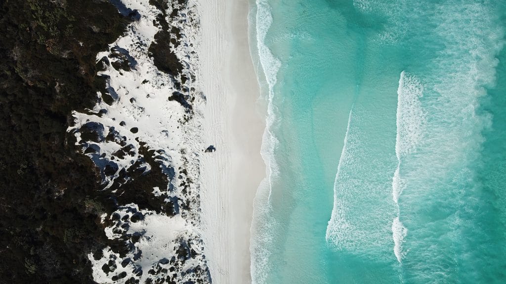 View from above a beautiful white sand beach and clear blue waters on the Coral Coast in Western Australia.